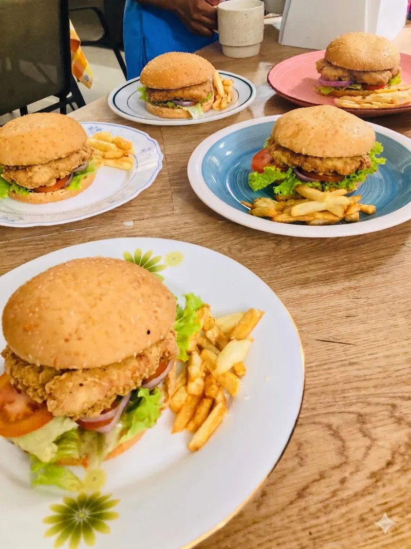 Homemade chicken burgers and chips served on individual plates