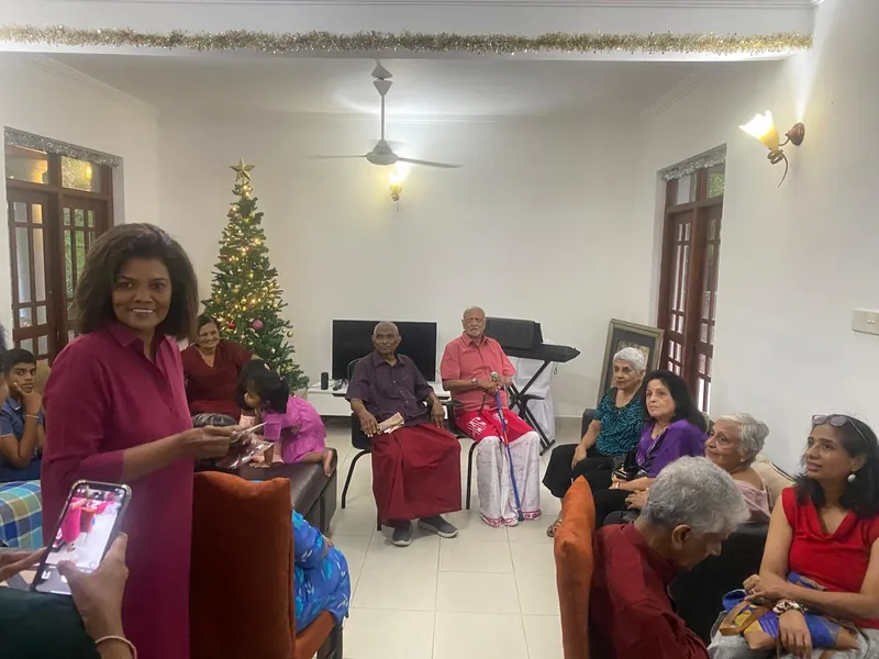 Residents and visiting families gathered in the decorated living room at Christmas