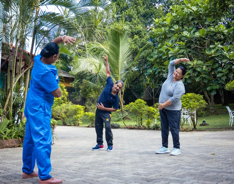 Residents doing gentle outdoor exercises in the garden
